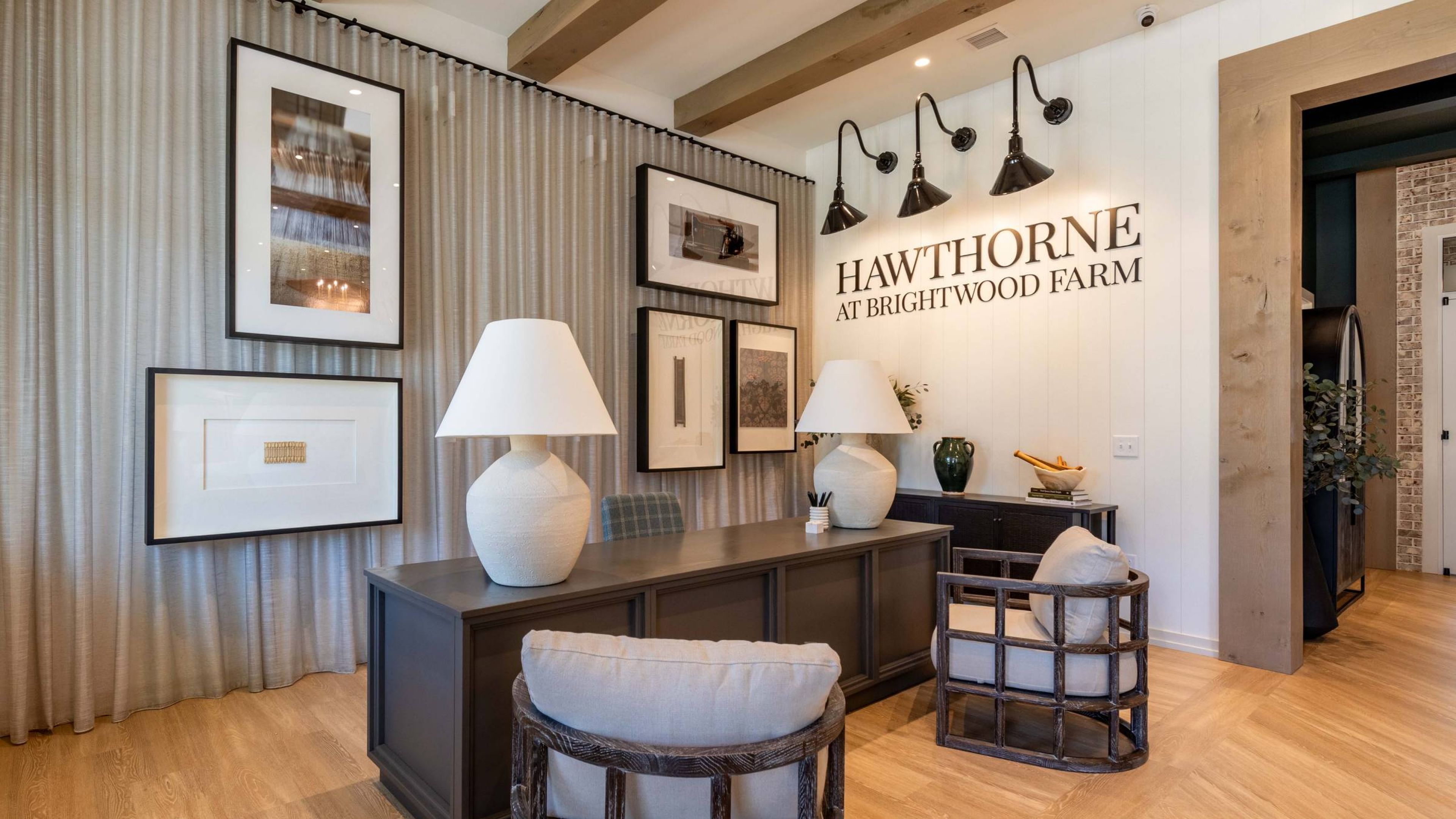 Hawthorne at Brightwood Farm welcoming office space that is elegantly decorated with framed art, stylish lighting, and comfortable seating for residents and guests.