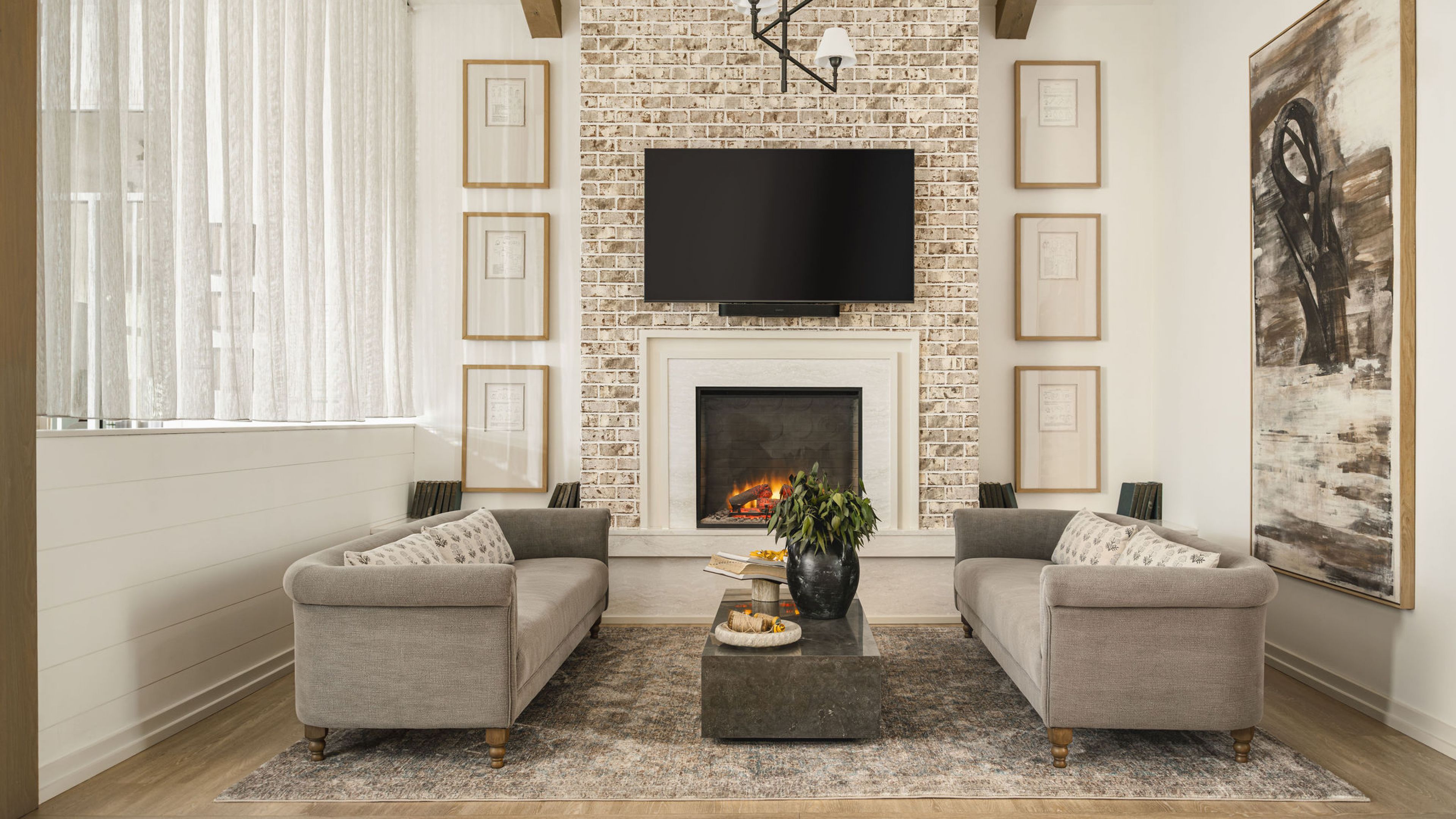 Hawthorne at Brightwood Farm inviting lounge area featuring comfortable seating, a chess table, and a modern open kitchen with rustic decor elements.
